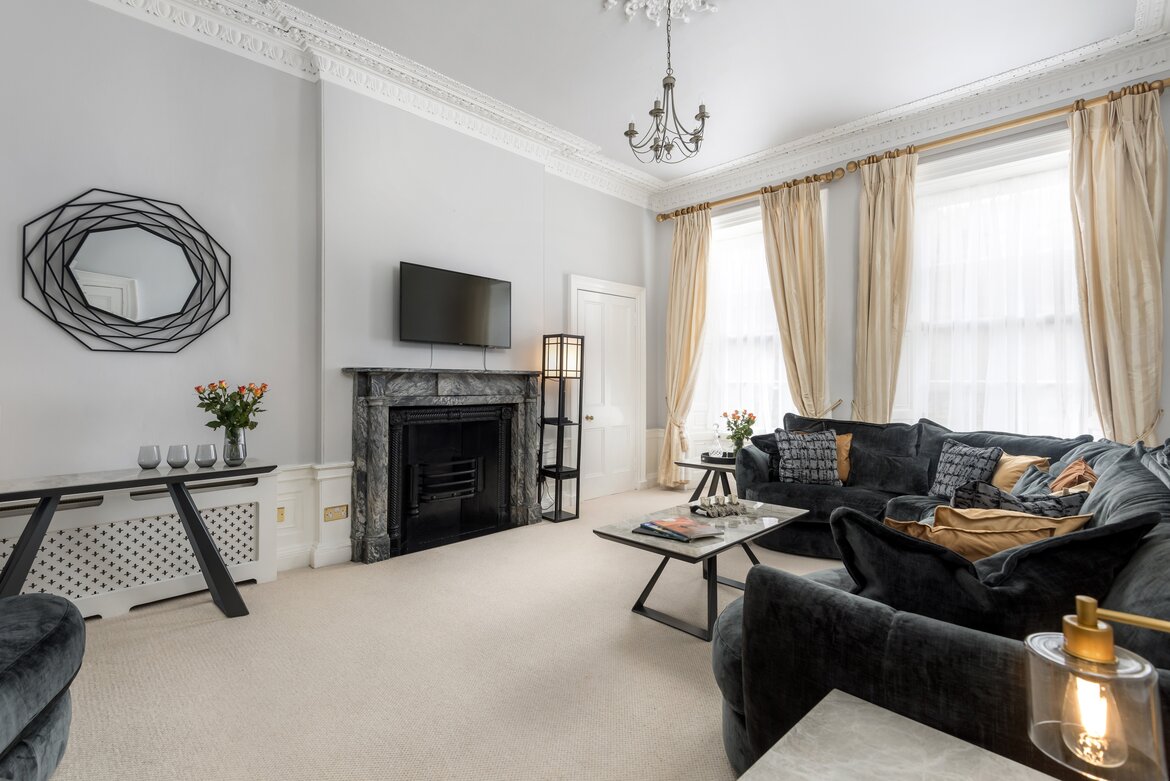Sophisticated Living Room in a Holiday Let - A light-filled, spacious lounge featuring a fireplace and plush seating for large groups