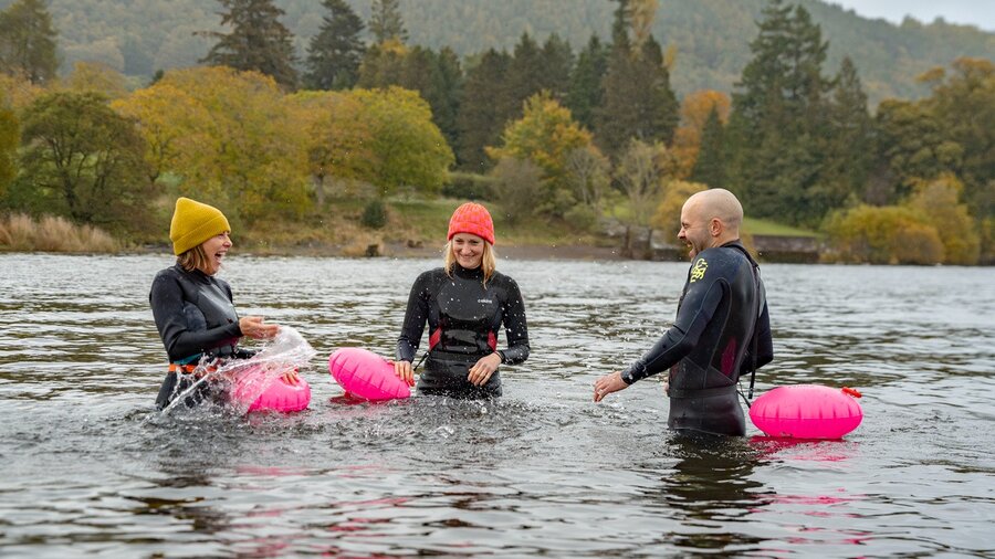 20241017_PaulMitchell_CUMBRIATOURISM_AnotherPlace_-101 - 3 people wild swimming in Ullswater (© www.lakedistrict.com)