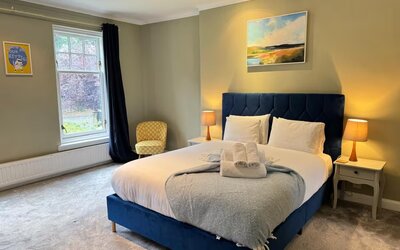 Double Bedroom for Business Travellers - Sink into comfort in this stylish bedroom with a plush blue bed and calming décor