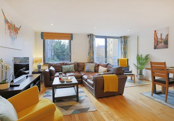 Living room - A bright, and spacious living/dining room featuring floor to ceiling windows in Edinburgh self catering holiday home.