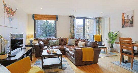 Living room - A bright, and spacious living/dining room featuring floor to ceiling windows in Edinburgh self catering holiday home.