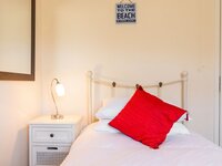 Single bed in bedroom in a beach cottage in Norfolk