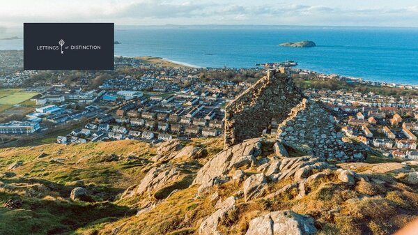 View from the North Berwick Law - A ruined building standing high above a coastal town. (© Kenny Lam)