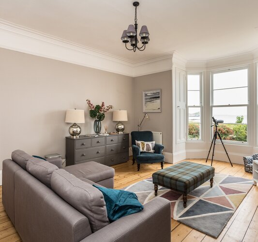 Lower Deck - Bright and spacious sitting room with uninterrupted sea views