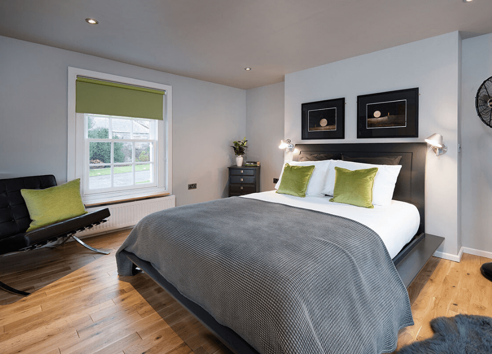 Fleet Cottage - Green highlights throughout the bedroom, with generous bed and wooden floors.