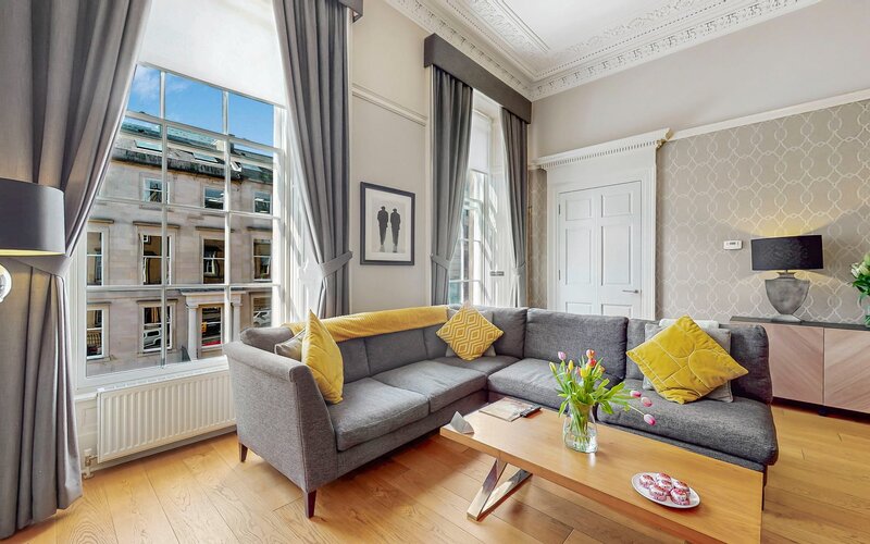 40-web-or-mls-242 West George Street MacKintosh Apartment_40 - Bright and stylish living space with comfortable seating and big windows