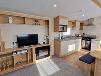Lounge with TV and Fireplace and Kitchen Area