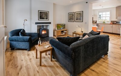 TV Lounge in a Holiday Stay - Spacious comfy seating featuring stylish décor and a fireplace