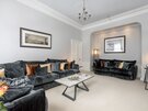 Family-friendly Living Room in Edinburgh - Another stunning vantage point of the living area, showcasing a second matching velvet sofa neatly tucked into a beautiful, softly lit arched alcove
