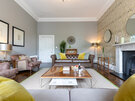 Lounge in a Holiday Rental in Edinburgh - Spacious living room featuring sumptuous seating, a large table, a fireplace and chic décor