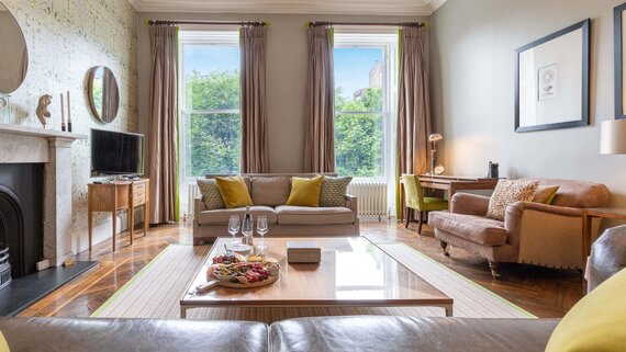 Lounge Area in a Self-Catered Apartment - Stylish living room featuring comfortable sofas and stunning views, to unwind after a long day in the city of Edinburgh