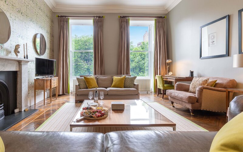 Lounge Area in a Self-Catered Apartment - Stylish living room featuring comfortable sofas and stunning views, to unwind after a long day in the city of Edinburgh