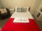 Bedroom - Double bed with accent soft throw in Edinburgh holiday home.