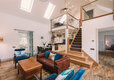 Wide angle view of sitting room, mezzanine and through to downstairs bedroom