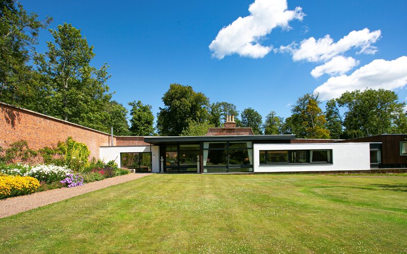 Grand Entrance to the Secret Walled Garden - A welcoming façade set amidst lush greenery, offering a glimpse into the tranquillity and elegance that awaits within this exclusive retreat.​
