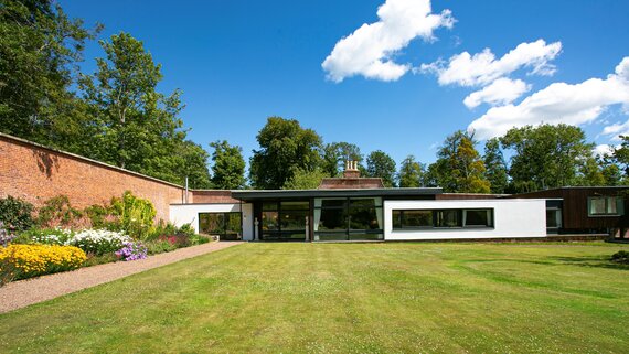 Grand Entrance to the Secret Walled Garden - A welcoming façade set amidst lush greenery, offering a glimpse into the tranquillity and elegance that awaits within this exclusive retreat.​