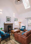 Part of the sitting room; leather couch with velvet armchairs