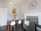 The Forrest Road Residence - kitchen/diner - Dining area in the kitchen, with large wall clock and cooker