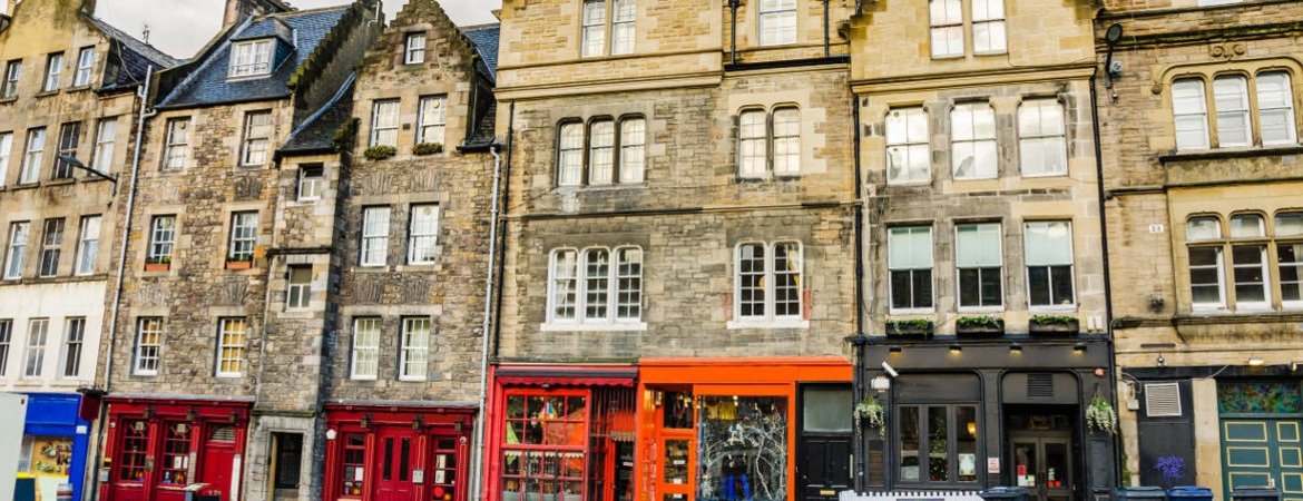 Row of colourful pubs and shops in Edinburgh Grassmarket