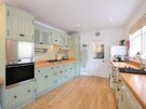Primrose Cottage - kitchen - Kitchen at Primrose Cottage, featuring a dishwasher, washing machine, oven and microwave