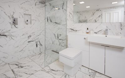 Modern Bathroom in a Private Residential Tenancy - Big and contemporary bathroom featuring a walk-in shower, toilet, sink and a large mirror