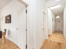 Hallway in The Lothian Road Residence in Scotland - Light and airy hallway with wooden floors and view to family dining area.