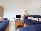 Law View - Navy blue sumptuous sofas in the living area of North Berwick self catering holiday rental.