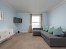 Living Room with Firth of Forth Views - Relax on the comfortable sofa while enjoying natural light and beautiful north-facing views towards the Firth of Forth. A peaceful retreat after exploring Edinburgh's vibrant Festival atmosphere.