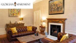 Case Study The Georgian Apartment - The living room with wooden fireplace and two luxurious leather sofas. Case Study The Georgian Apartment - The living room with wooden fireplace and two luxurious leather sofas.