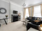 Spacious Living Room in a Holiday Rental - A grand and sophisticated period living room that masterfully combines traditional regal details with contemporary comfort