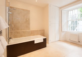 Luxurious Bathroom with bath and shower over bath