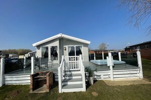 front lodge view with bbq and balcony - view of the front of the lodge, garden furniture, bbq, hot tub