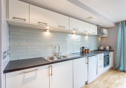 KITCHEN WITH FEATURE TILED SPLASHBACK WALL