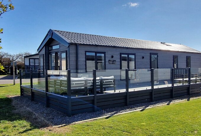 Outside view of Belvis Lodge - Outside view of Belvis lodge with large veranda all the way around the front and sides. Patio doors from the lounge lead onto the veranda with is large seating areas