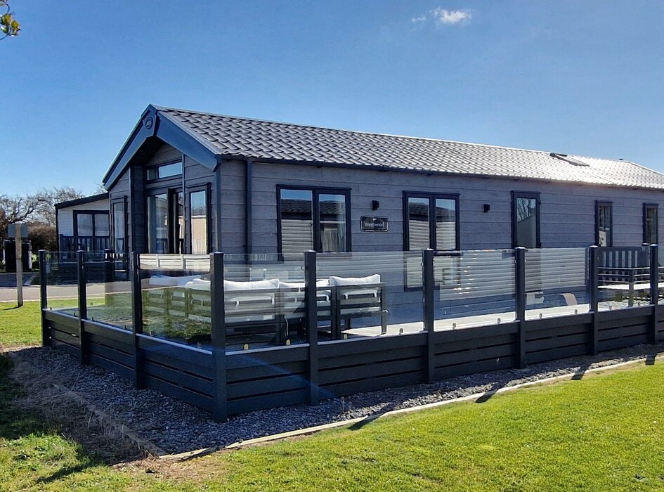 Outside view of Belvis Lodge - Outside view of Belvis lodge with large veranda all the way around the front and sides. Patio doors from the lounge lead onto the veranda with is large seating areas