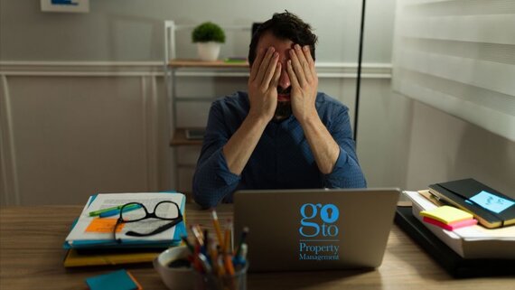 Going it alone - man overwhelmed with self-managing his holiday rental  while children play in background