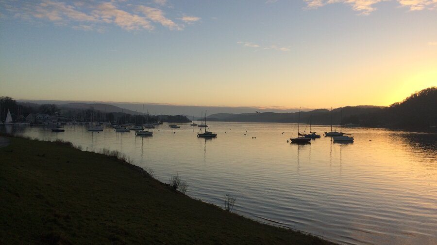 Sunset over Lake Windermere - Boats moored on Lake Windermere enjoying stunning sunset views from Cockshot Point near Bowness on Windermere (© Cumbria Tourism)