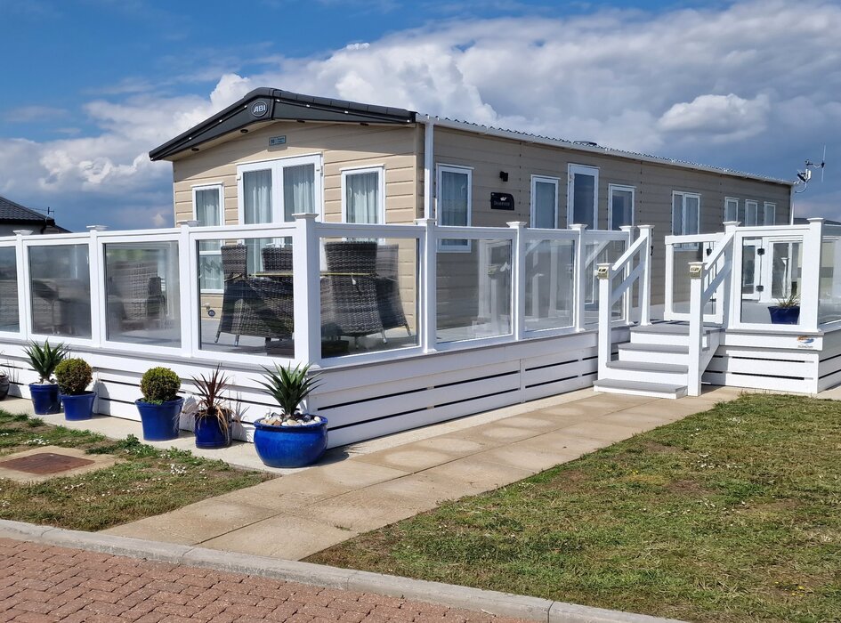 Beaumont, West Point Lodge - Beaumont a lovely lodge in West Point with terrace around the property with seating area at the front with a partial sea view. There is a private parking space at the rear of the property.