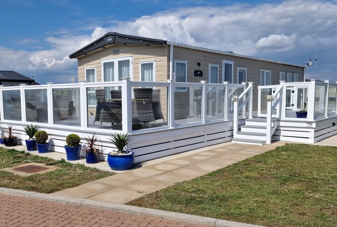 Beaumont, West Point Lodge - Beaumont a lovely lodge in West Point with terrace around the property with seating area at the front with a partial sea view. There is a private parking space at the rear of the property.