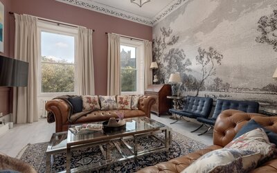 Elegant Living Room with Castle Views - A bright and spacious living area featuring large windows framing breath-taking views of Edinburgh Castle. Designed with luxury in mind, the space combines modern comfort with timeless style - perfect for relaxing after a day exploring the city