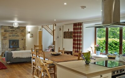 The Steading kitchen_dining room - Large fully equipped kitchen/dining room with settee and stairs to bedrooms