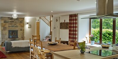 The Steading kitchen_dining room - Large fully equipped kitchen/dining room with settee and stairs to bedrooms