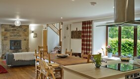 The Steading kitchen_dining room - Large fully equipped kitchen/dining room with settee and stairs to bedrooms