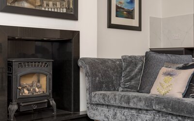 Living Room - Beautiful, sumptious sofa and feature fireplace in Edinburgh holiday home.