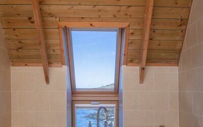 Bright Bathroom in Rural Scotland - Elegant bathroom featuring a deep soaking tub, for ultimate relaxation and indulgence under a vaulted timber ceiling