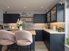 Modern Navy Kitchen with Island - The sleek navy kitchen features integrated appliances, generous storage, a timber island and stylish seating, providing everything needed for luxury self-catering accommodation in Edinburgh.