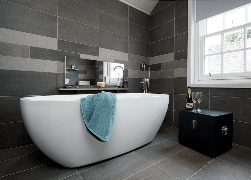 Fleet Cottage - Luxurious bathroom with freestanding tub and stunning tiles