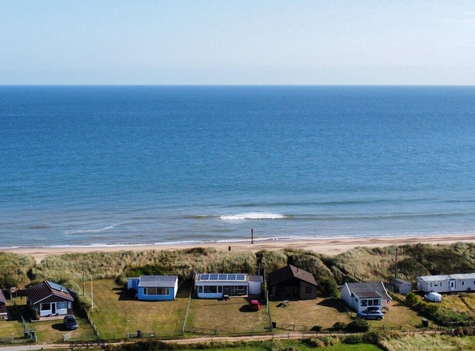 A view of Eccles on Sea Beach from above. - With the sea behind and stunning countryside views  to the front you have the best of both worlds. With a large dog proof garden and plenty of space for parking.