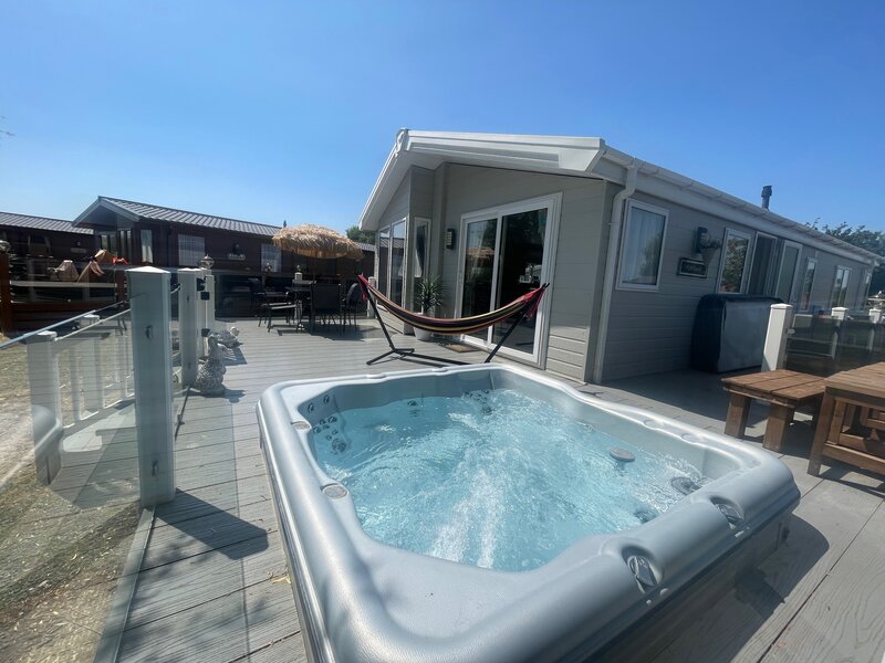 hot tub side view of lodge, garden furniture and hammock