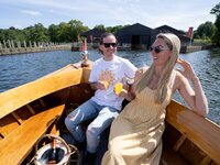 Wooden boat with couple on Lake Windermere in the Lakes